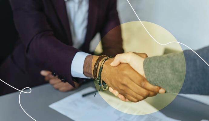Two therapists shake hands after agreeing on a therapist non-compete agreement