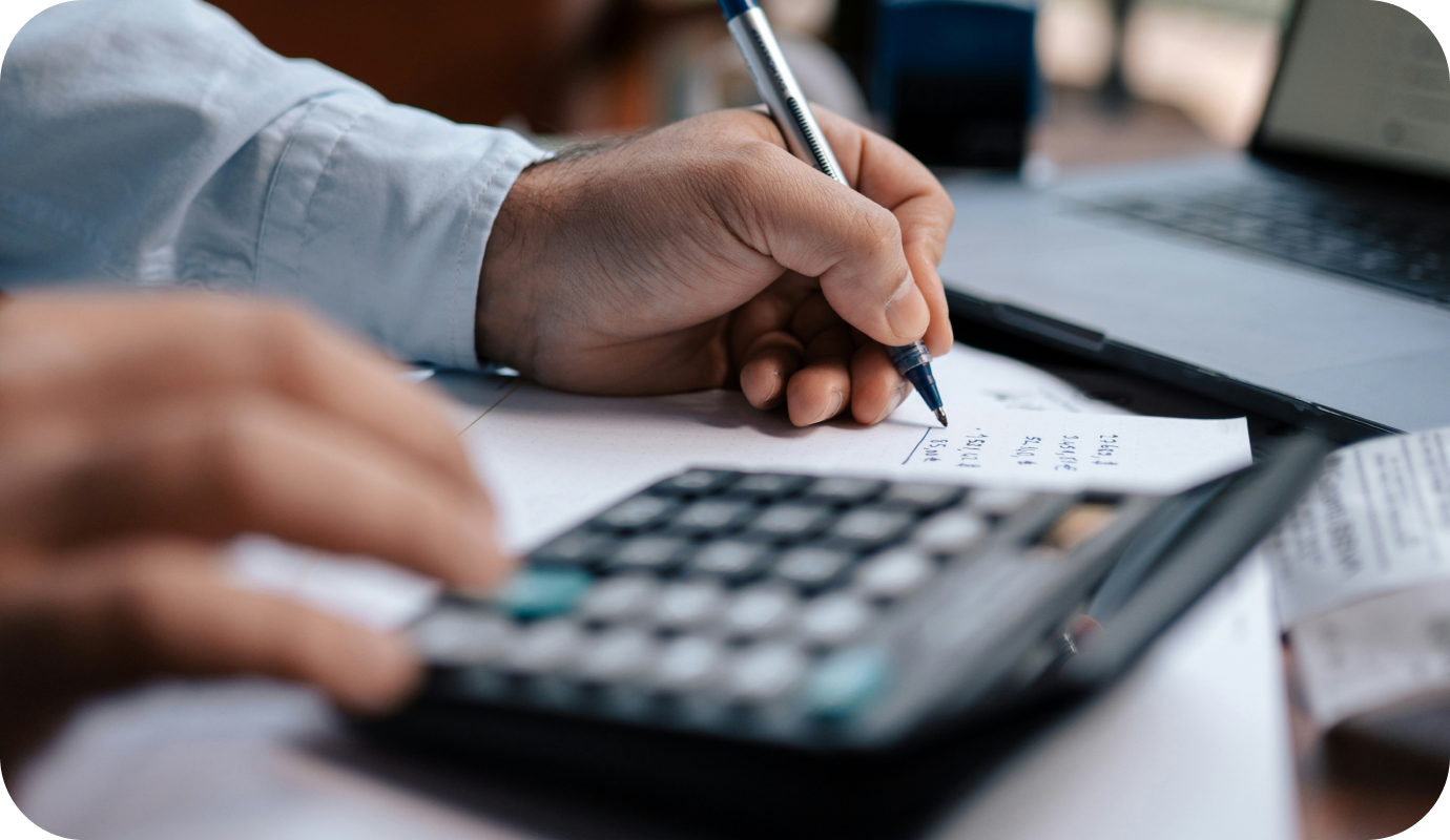 A therapist uses a calculator and writes down expenses and deductions, factoring in the tax write-offs for therapists. Learn about 11 overlooked tax write-offs for therapists that you can include in your 2024 business tax filings.