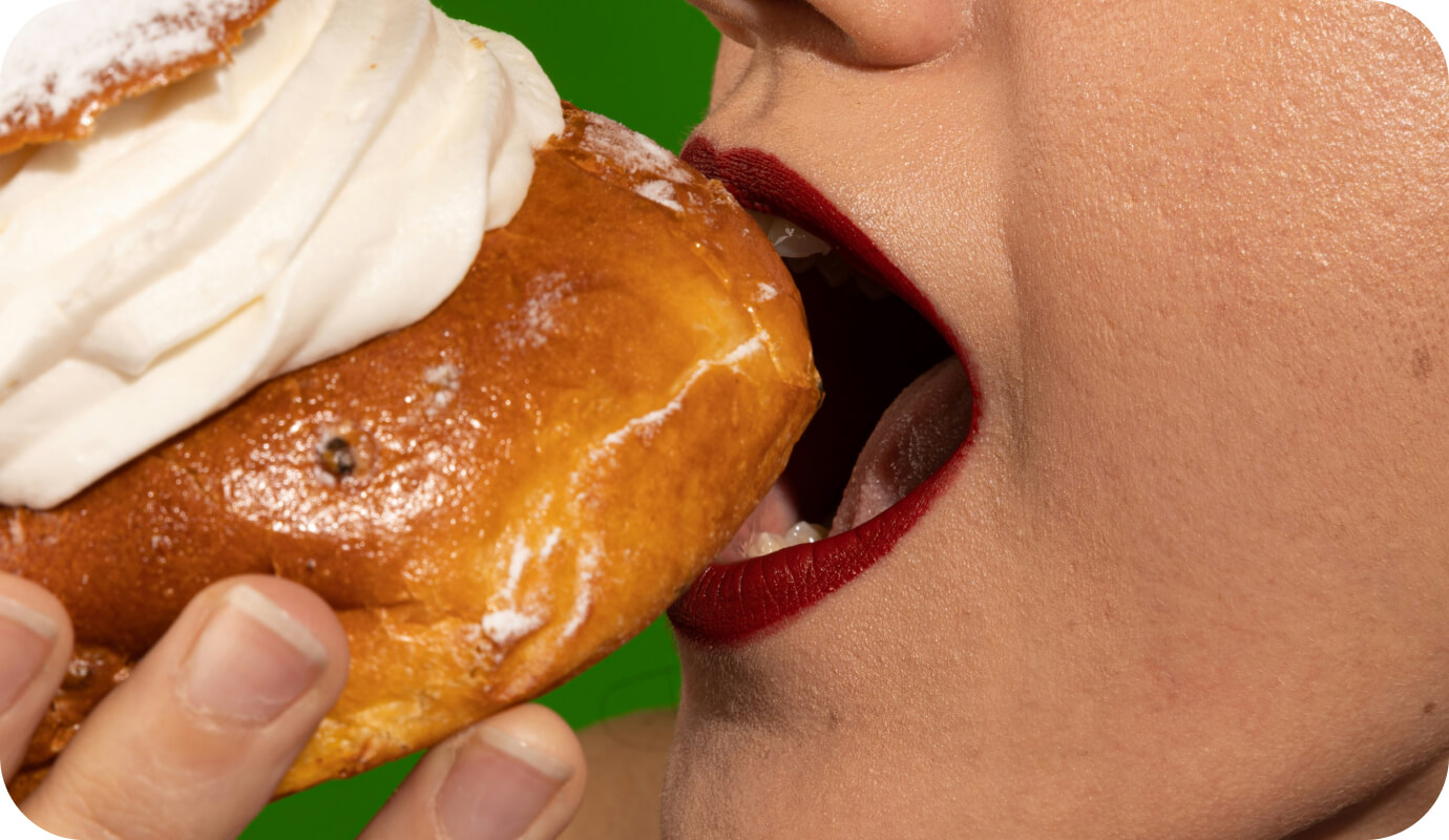 A woman who may be worried about disordered eating at the holidays eats a pastry