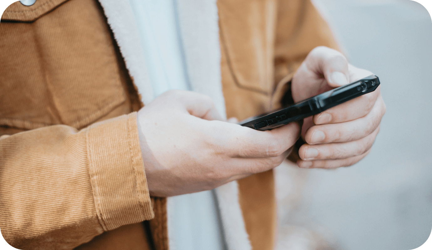 A therapist is on his mobile phone as he checks his emergency contact procedures for private practice