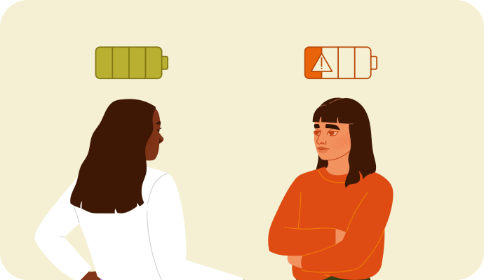 An illustration of a therapist, who is experiencing compassion fatigue, a low battery image is above their head. Across from them is another person, who has their corresponding battery charged, signifying that they're not experiencing compassion fatigue. In this article we discuss compassion fatigue therapists experience, how to manage these symptoms, and how to take measures to avoid therapist burnout.