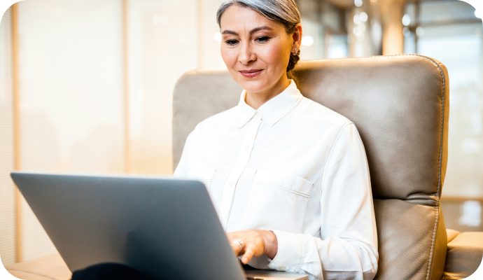 A therapist sits with her laptop open and looks through all the new features added to her SimplePractice account in 2024. Read about all the features SimplePractice released in 2024 to help you manage, build, and improve your private practice.